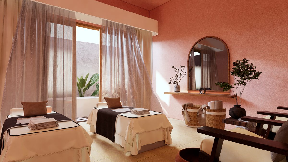 Spa treatment room with twin beds, sheer curtains and an arched mirror on a terracotta wall
